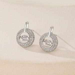 Elegant geometric silver earrings with dancing zircon stones on a minimalist background