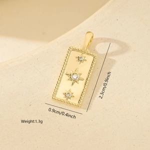 Detailed close-up of a square gold pendant featuring three cubic zirconia with starburst engravings