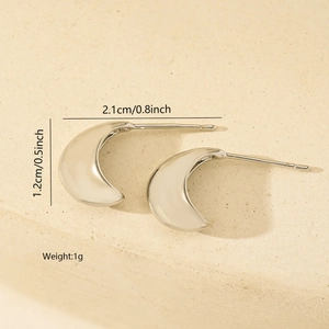 Detailed view of silver crescent earrings with dimensions 2.1cm and 1.2cm on stone base
