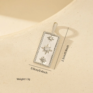 Close-up of square metal pendant with three zircon stones in star settings for jewelry DIY