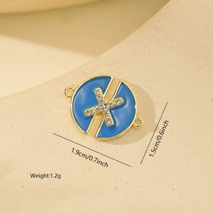Macro detail of sky blue enamel round pendant with X-shaped zircon for DIY jewelry