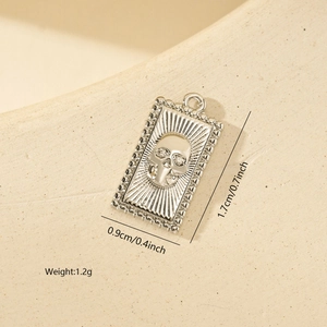 Detailed view of rectangle skull pendant with dimensions 1.7cm x 0.9cm and 1.2g weight