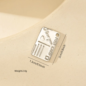 Detailed macro view of silver postcard pendant with I Love You engraving and heart