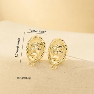 Detailed macro view of vintage gold relief portrait stud earrings on stone texture