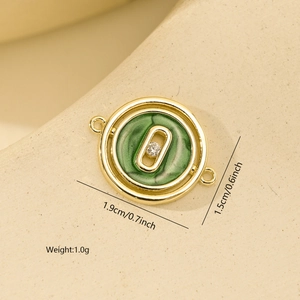 Close-up of golden round pendant with green marble enamel and center diamond for DIY jewelry