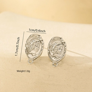 Macro view of vintage silver metal earrings with embossed portrait detail for DIY jewelry