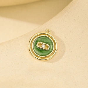 Golden double-ring pendant with green enamel inlay and sparkling central cubic zirconia