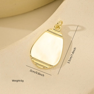 Detailed view of polished gold plated oval pendant with horizontal grooves and dimensions