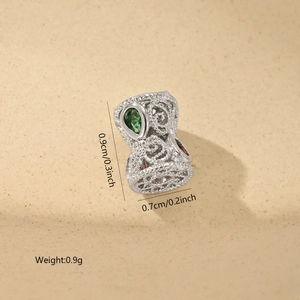 Detailed view of silver hollow bead with green zircon and 0.9x0.7cm size specs