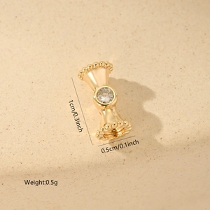 Detailed close-up of a gold-plated spacer bead with zircon inlay for jewelry making