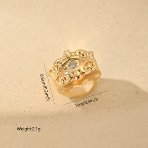 Detailed view of evil eye gold bead with clear zircon inlay measuring 1cm by 0.6cm