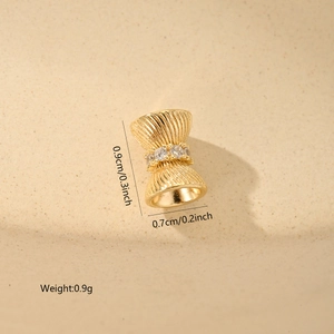 Macro detail of a gold-plated bow charm with cubic zirconia for DIY jewelry making