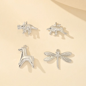 Silver animal charms including dinosaur, giraffe, and dragonfly for DIY jewelry making