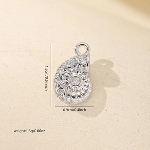 Detailed view of sea snail pendant with dimensions 1.5cm by 0.9cm and zircon inlay