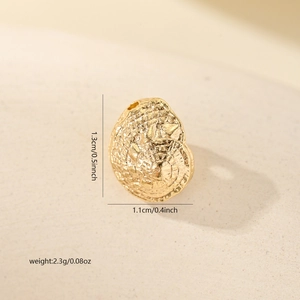 Macro view of a gold conch shell pendant with zircon inlays and detailed spiral texture