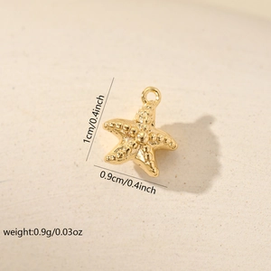 Macro view of gold starfish charm with beaded texture showing 1cm x 0.9cm dimensions