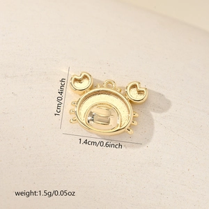 Macro view of gold-plated crab pendant with dimensions 1.4cm width and 1cm height