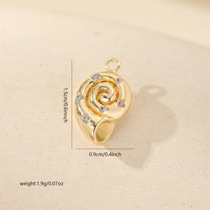 Detail view of a 15mm gold conch shell pendant with cubic zirconia and size dimensions