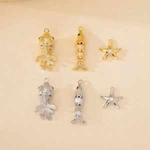 Detailed set of gold and silver koi fish and starfish metal pendants for DIY jewelry making