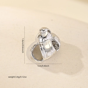 Detailed view of polished copper sea shell pendant with cubic zirconia for jewelry making