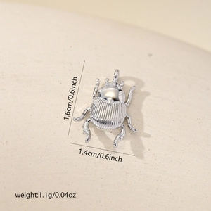 Detailed size chart of a 1.6cm silver beetle pendant with weight and dimensions info