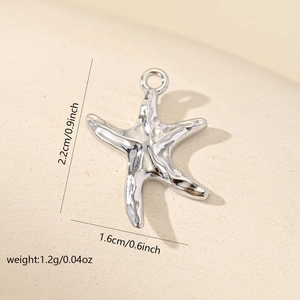 Macro view of silver starfish pendant showing detailed 2.2cm height and 1.6cm width dimensions