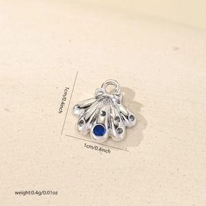 Macro detail of silver shell pendant with blue zircon stone and dimensions info