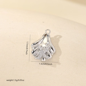 Macro detail of a silver shell pendant with zircon starfish inlay, size 1.7cm x 1.3cm