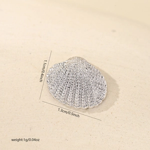 Macro detail of 1.3cm silver plated shell pendant with textured finish for DIY jewelry