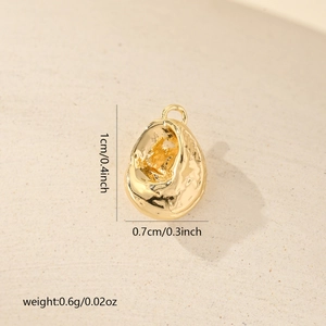 Detailed view of a gold-plated seashell charm with natural texture and size dimensions