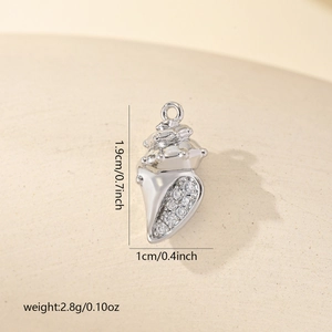 Macro detail of silver conch pendant showing dimensions 1.9x1.0cm and cubic zirconia inlay