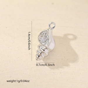 Macro shot of a conch shell pendant in silver metal with zircon inlays and dimensions