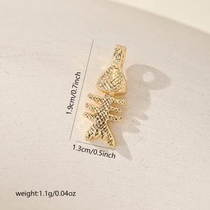 Detail of golden fishbone pendant with textured finish showing 1.9cm x 1.3cm dimensions