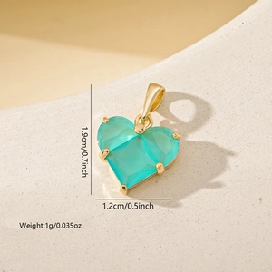 Macro shot of mint green heart pendant with gold plating and size measurement details