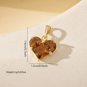 Detailed view of faceted heart pendant in gold finish with 1.9cm height measurement