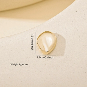 Macro view of irregular gold plating earrings with vintage metal texture and dimensions
