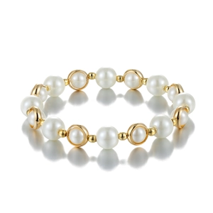 Elegant gold metal ring and pearl beaded bracelet with a polished mirror reflection
