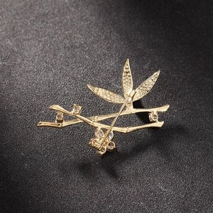 Detailed back view of gold-plated bamboo brooch with sparkling crystals and pin closure