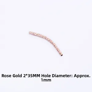 Macro detail of rose gold 2x35mm curved brass tube bead with diamond-cut texture for DIY jewelry