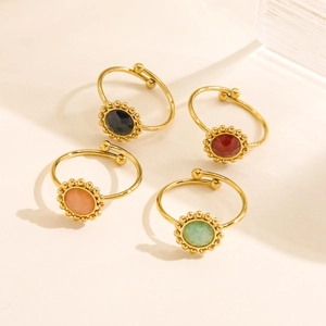 Four vintage adjustable gold rings set with colorful round gemstones in sunflower bezel