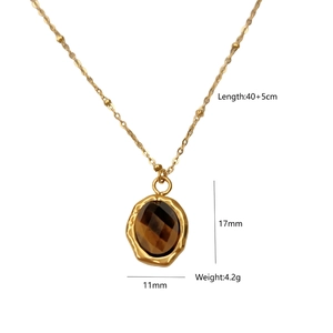 Detail of 14K gold plated necklace with faceted brown stone and hammered texture metal