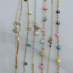 Golden stainless steel jewelry set with natural stone, pearls and mixed charms