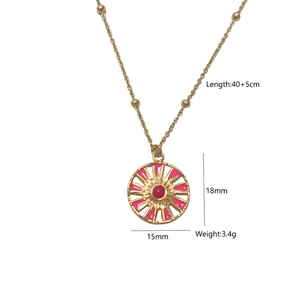 Detail view of gold compass necklace with pink enamel and red stone 18x15mm pendant