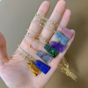 Gold necklaces set featuring trapezoid natural stone pendants in various gemstones