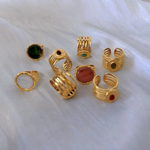 Bohemian gold stainless steel rings set with natural stones on white silk fabric