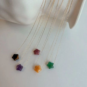Luxury gold necklaces featuring natural stone star pendants in five vibrant colors