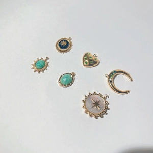 Bohemian gold plated charms set with green gemstones and celestial enamel motifs
