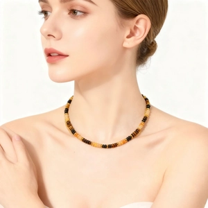 Tiger eye bead necklace with gold spacers and stainless steel pendant on model