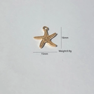 Macro detail of a 16x15mm golden starfish charm with biological texture and ring