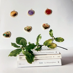 Gold stainless steel heart and natural stone pendants set on elegant vintage books